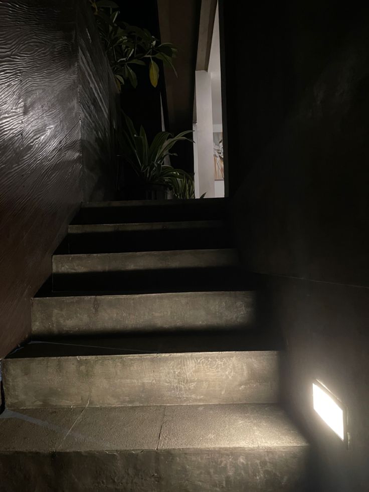 the light is shining on some concrete steps