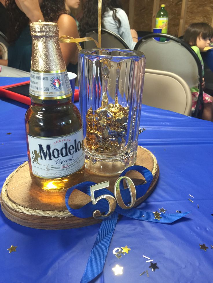 a bottle of modelo and a glass on a table with confetti in it