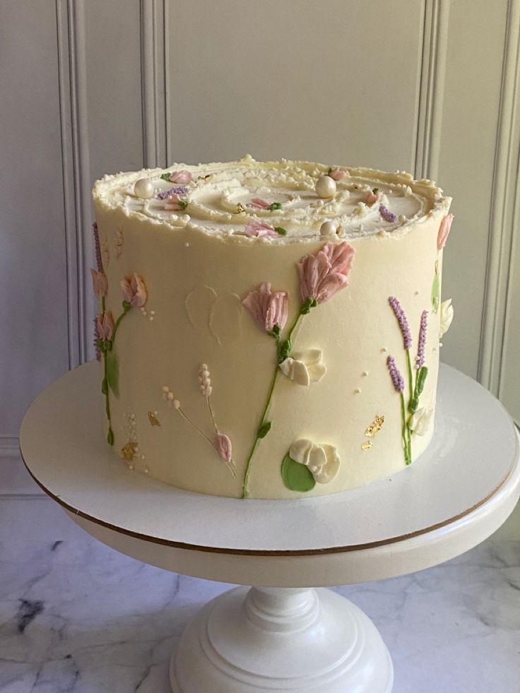 a white cake with pink flowers on it