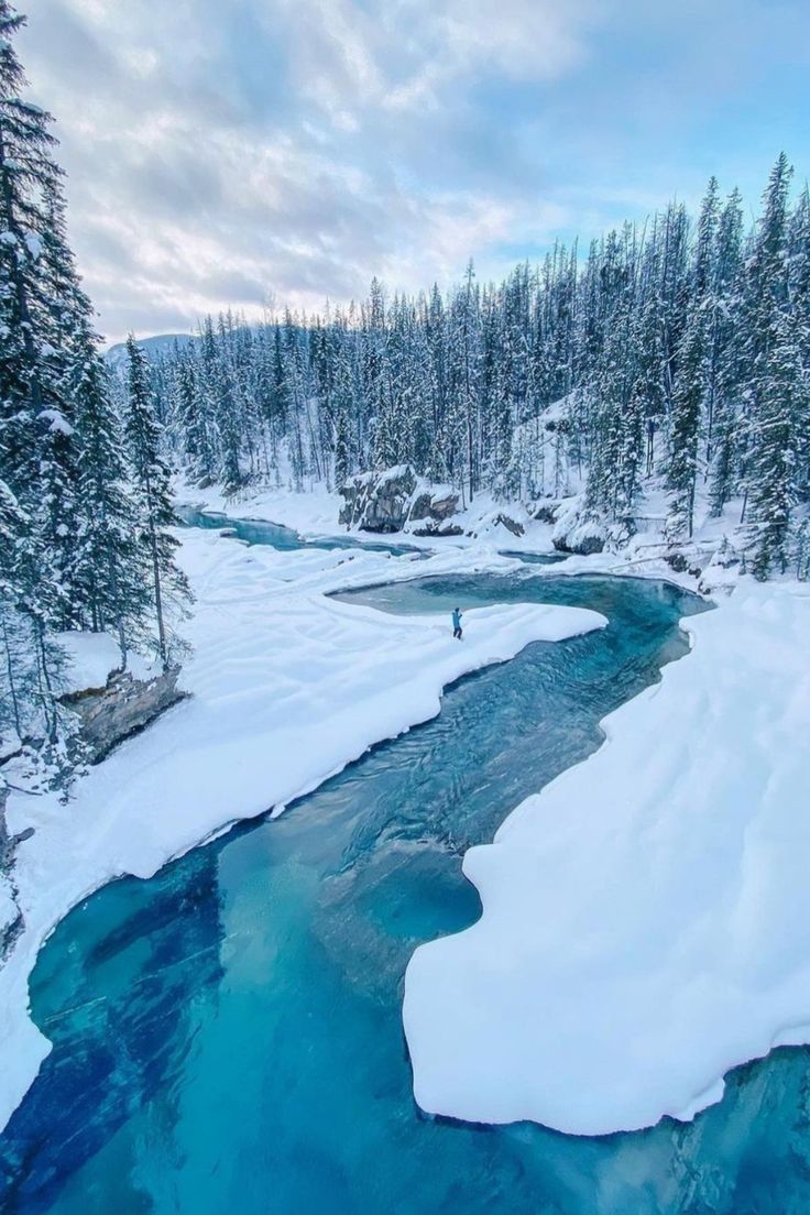 a river running through a snow covered forest