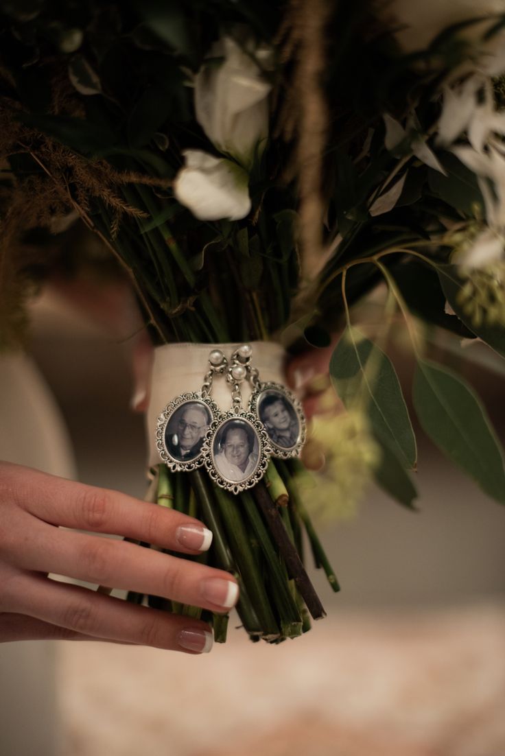 a person holding flowers with two pictures on them