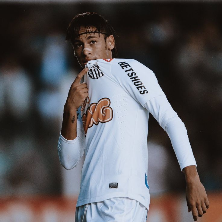 a soccer player is holding his finger to his mouth