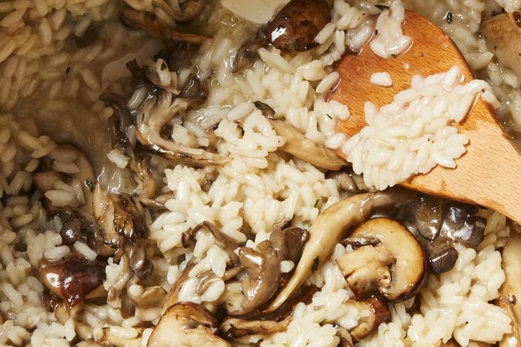 rice and mushrooms are mixed together in a bowl