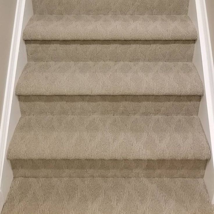 a carpeted staircase leading up to the second floor