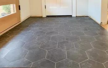 an empty room with black tile floors and white doors