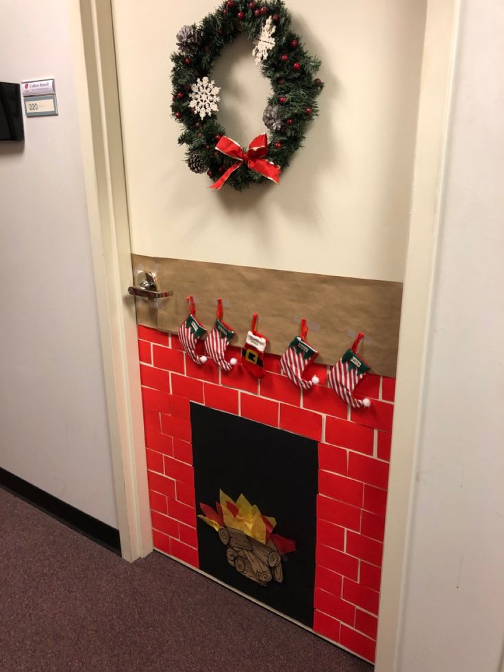 a fireplace decorated for christmas with decorations on the mantel and wreath above it in an office hallway