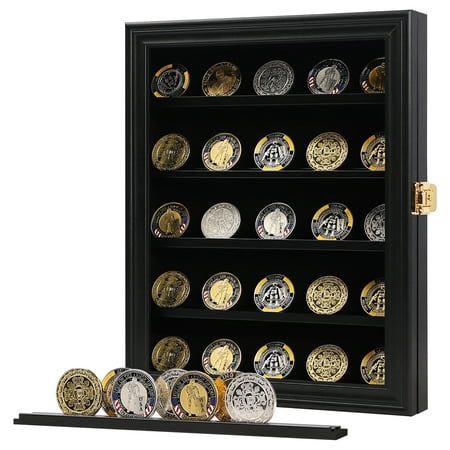 a black and gold coin display case with coins on the bottom, in front of it