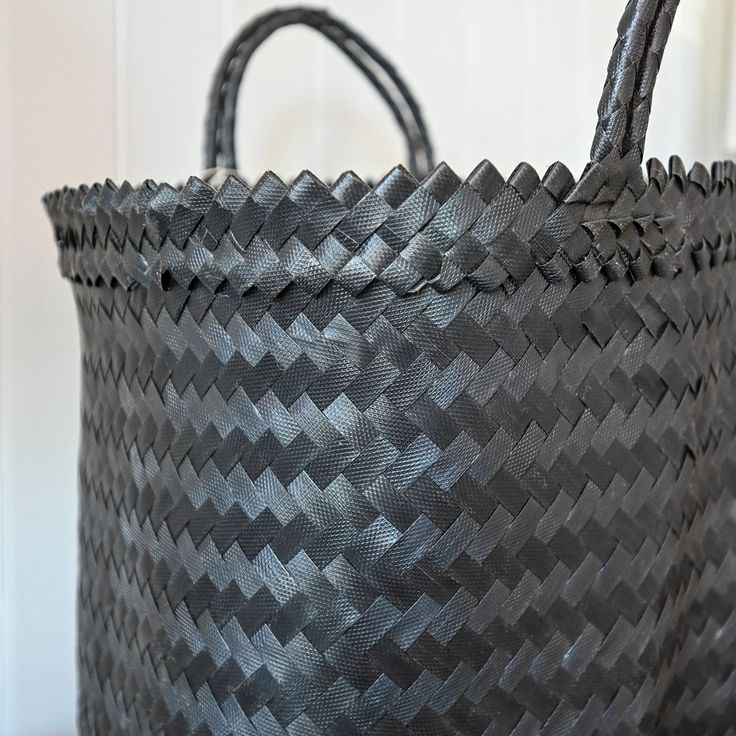 This generously sized tote exudes a blend of style and practicality, ideal for both the market and beach trips. Its comfortable handles will make this your new favorite bag of the season. Everyday Black Handwoven Beach Bag, Black Woven Square Beach Bag, Black Handwoven Natural Fiber Beach Bag, Handwoven Black Beach Bag, Eco-friendly Black Woven Beach Bag, Black Weave, Beach Trips, Large Tote Bag, Large Tote