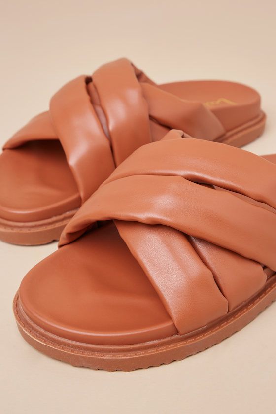 Your summer just got a lot more stylish, and it's all thanks to the trendy vibes of the Lulus Tolleson Cognac Slide Sandals! Smooth faux leather shapes these must-have sandals that feature an almond-shaped toe bed and a collection of wide, puffy straps that create a crisscrossing vamp. A smooth contoured insole and treaded rubber sole complete the slide-on silhouette. Available in whole sizes only. 1" rubber sole. Smooth insole. Rubber sole has nonskid markings. Man made materials. Imported. Lul Flat Faux Leather Beach Sandals, Beach Flat Faux Leather Sandals, Brown Leather Footbed Slides For Spring, Faux Leather Sandals For Beach In Summer, Faux Leather Sandals For Summer Beach, Faux Leather Sandals For Beach And Summer, Beach Sandals With Padded Heel And Open Toe, Trendy Leather Slide Footbed Sandals, Trendy Brown Footbed Sandals With Removable Insole