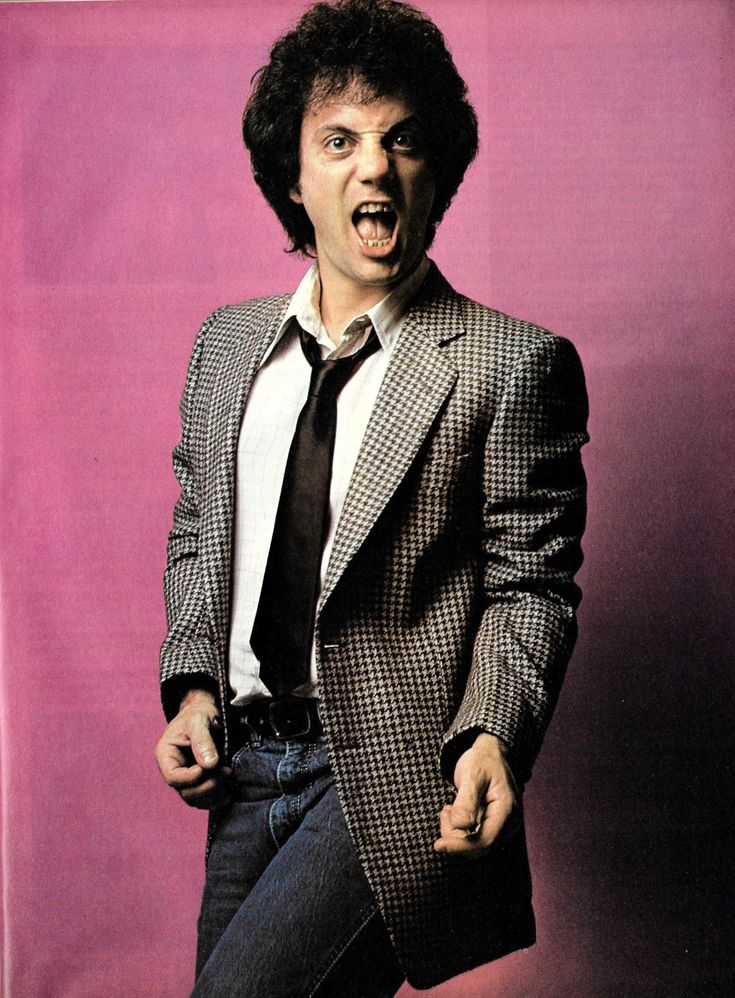 a man in a suit and tie with his mouth wide open, standing against a pink background