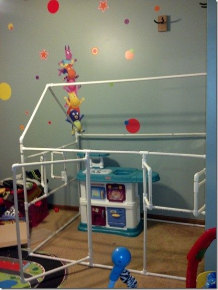 a child's room with toys and decorations on the walls, including a play area