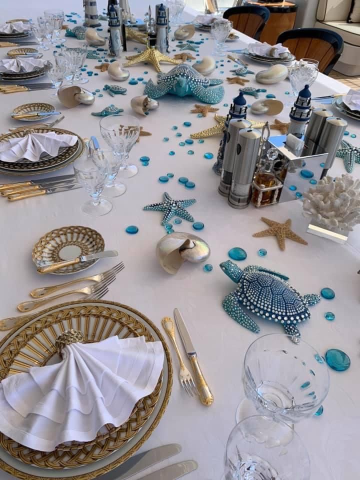 the table is set with blue and white decorations