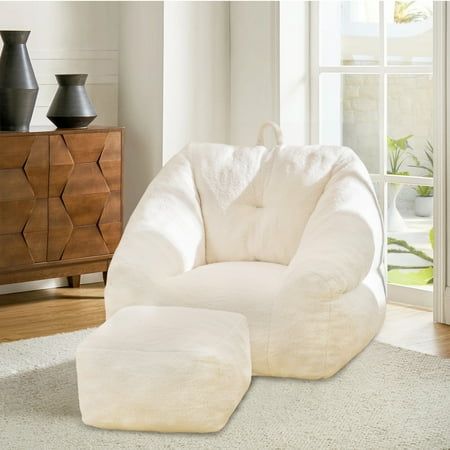 a white bean bag chair sitting on top of a rug in front of a window