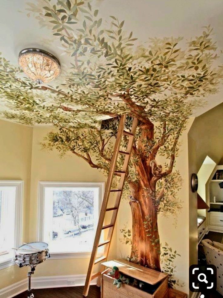 a tree painted on the ceiling in a room with windows and a ladder up to it