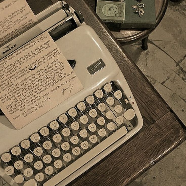 an old fashioned typewriter sitting on top of a table