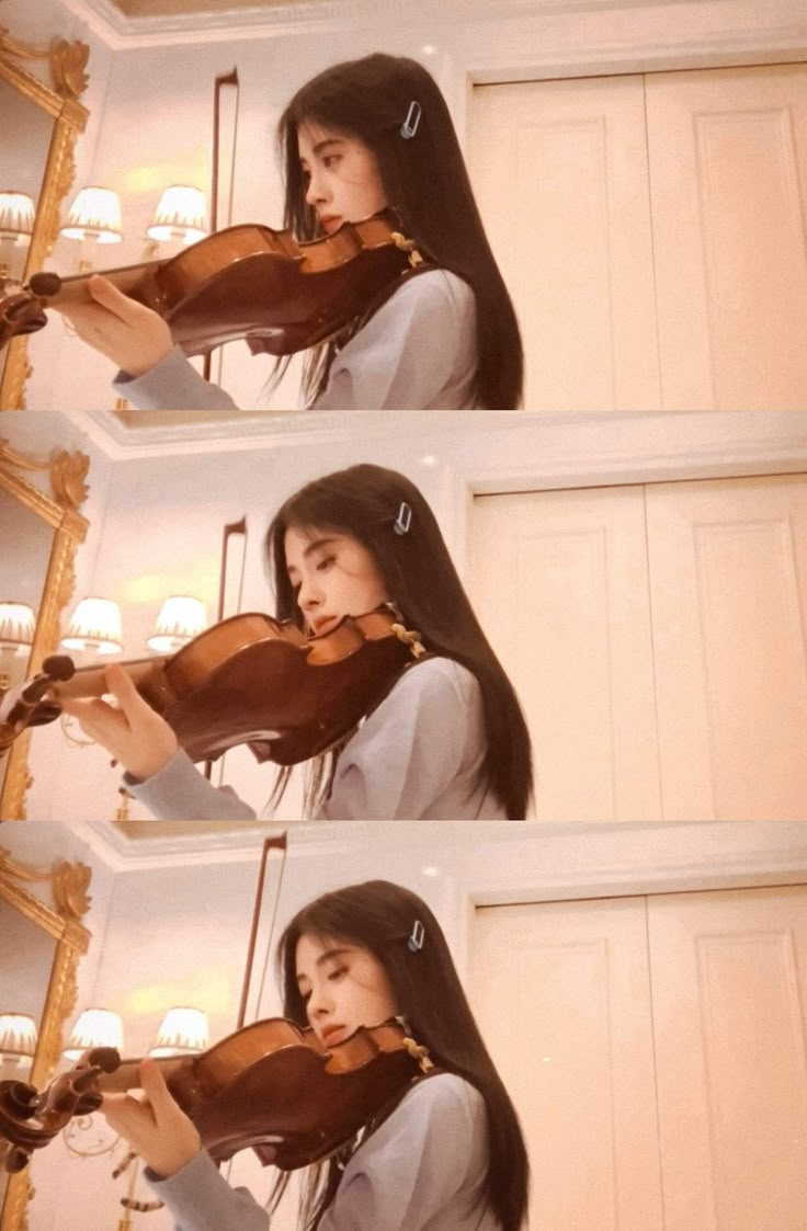 a woman holding a violin in her right hand