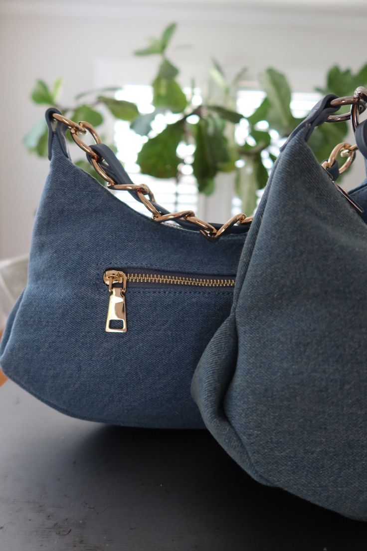 Created from durable denim, this handbag combines functionality with trendy aesthetic! With its versatile style, you’ll be adding this bag to every outfit this summer. Zipper closure Outside pocket 2 inside pockets Detachable strap Measurements: Width: 13” Height: 7.5” Denim Blue Canvas Shoulder Bag With Zipper, Denim Shoulder Bag With Zipper For Daily Use, Denim Shoulder Bag With Zipper For Travel, Daily Use Denim Shoulder Bag With Zipper, Daily Use Denim Shoulder Bag With Zipper Closure, Travel Denim Blue Shoulder Bag With Zipper, Denim Blue Bags With Zipper Pocket For On-the-go, Trendy Denim Blue Bag With Zipper Pocket, Everyday Denim Bags With Zipper Closure