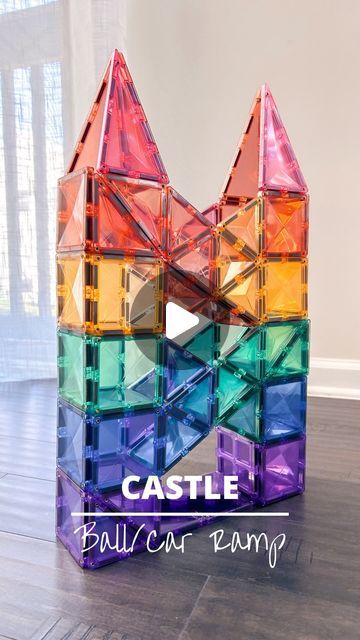 a colorful castle made out of plastic blocks with the words castle on it's side