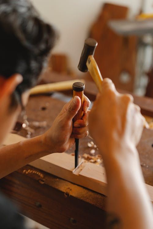 a person is working on something with a hammer