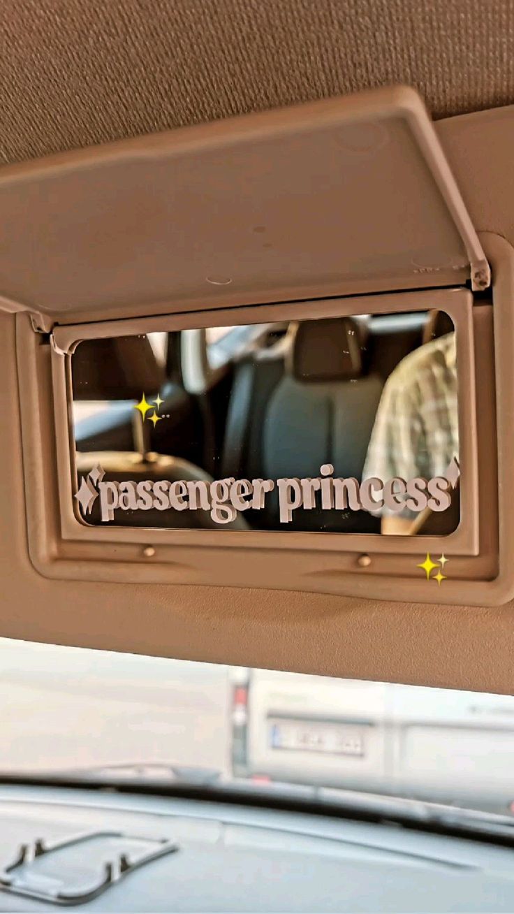 the passenger princess sign is hanging in the back seat of a car with its door open