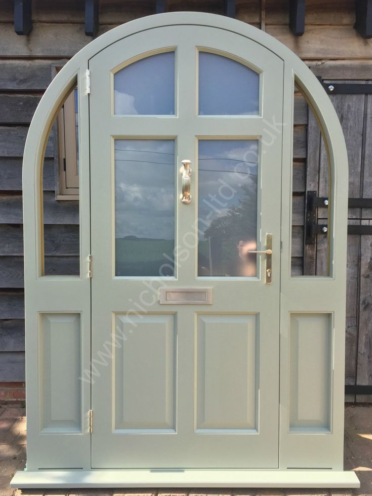 an arched door with glass on the outside