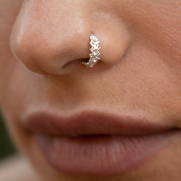 a woman with a nose piercing on her nose