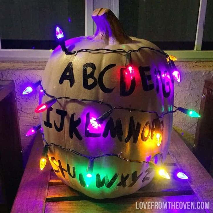 a large pumpkin decorated with lights and letters