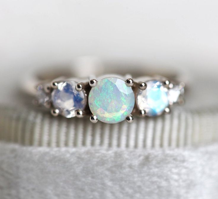 Australian Opal and Moonstone Cluster Engagement Ring by Capucinne Luxury Opal Ring With Accent Stones For Anniversary, Luxury Sterling Silver Opal Ring With Gemstone Accents, Opal Ring Simple Capucinne, Luxury Multi-stone Opal Ring Round Cut, Luxury Multi-stone White Gold Opal Ring, Moonstone Wedding Ring Capucinne, Australian Opal Ring Capucinne, Luxury Moonstone Opal Ring For Anniversary, Elegant Luxury Moonstone Ring With Ethiopian Opal