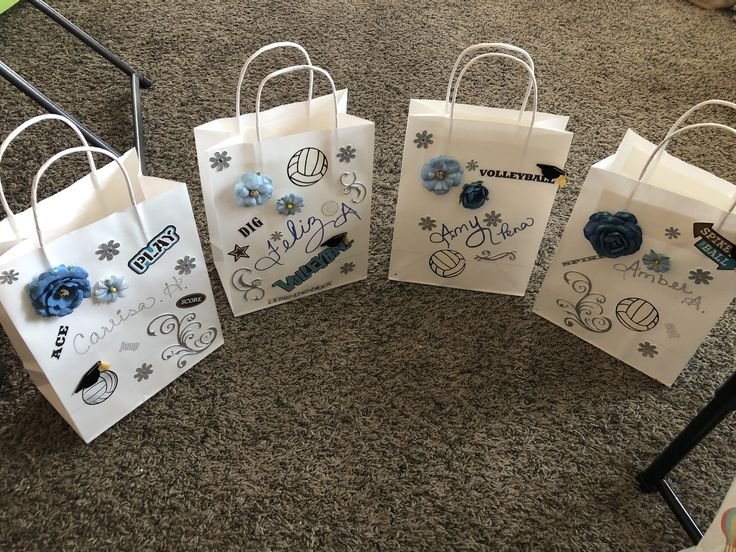 four bags with designs on them sitting on the floor