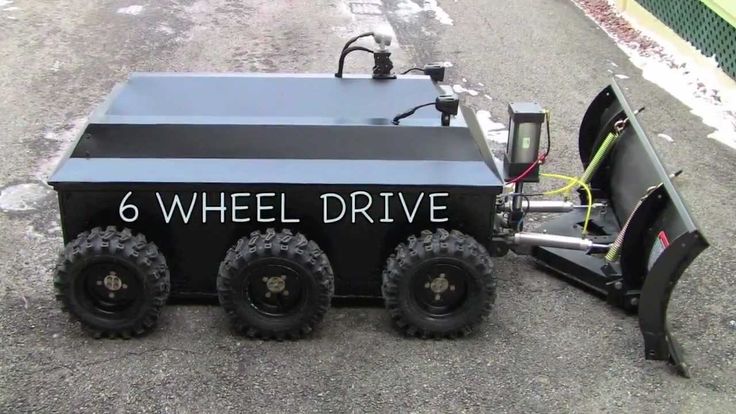 an off road vehicle is parked on the side of the road with its wheels down