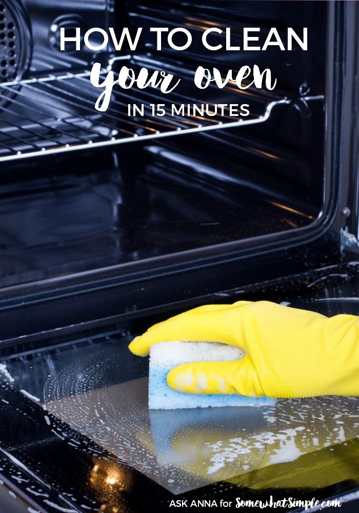 a person in yellow gloves cleaning an oven with a sponge on the stovetop and text overlay that reads how to clean your oven in 15 minutes