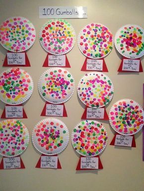 paper plates with different colored dots on them are arranged in the shape of a tree