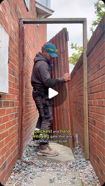 a man is standing in front of a brick wall and opening the door to another building