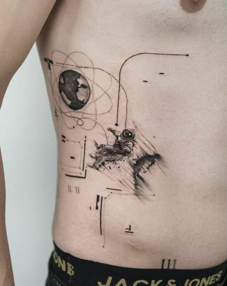 a man's stomach with an abstract tattoo on it