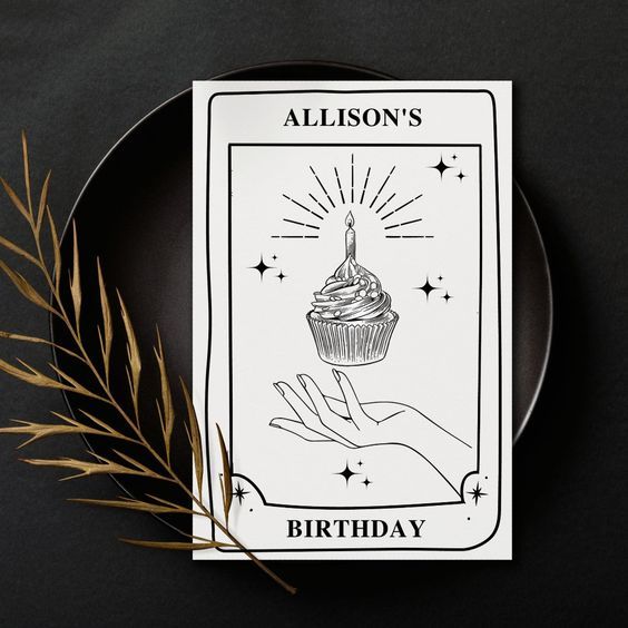 a black plate with a cupcake on it and a card that says, allison's birthday