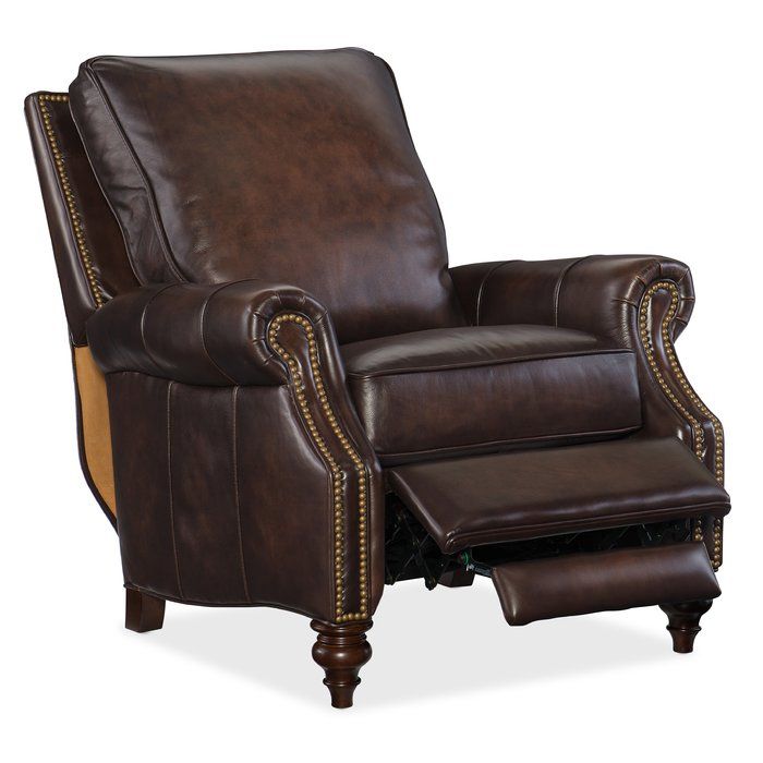 a brown recliner chair with nailing on the armrests and foot rest