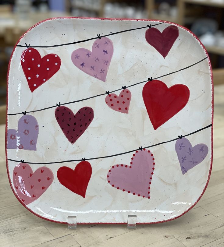 a plate with hearts on it sitting on a table