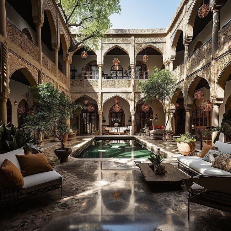 an indoor swimming pool in the middle of a courtyard with seating and potted plants