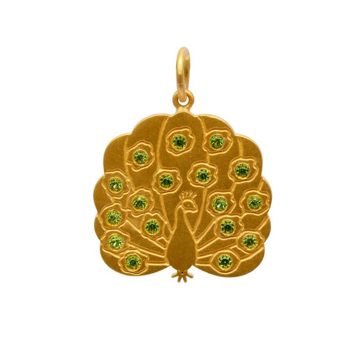 a gold pendant with green stones in the shape of a peacock