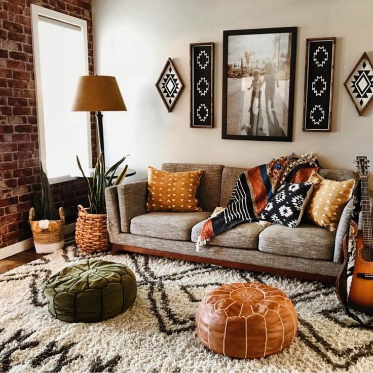 a living room filled with furniture and pictures on the wall