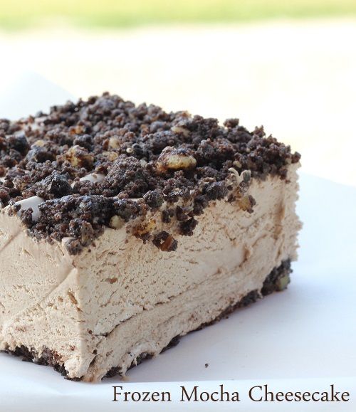 a piece of ice cream cake on a white plate with chocolate chips and oreo crust