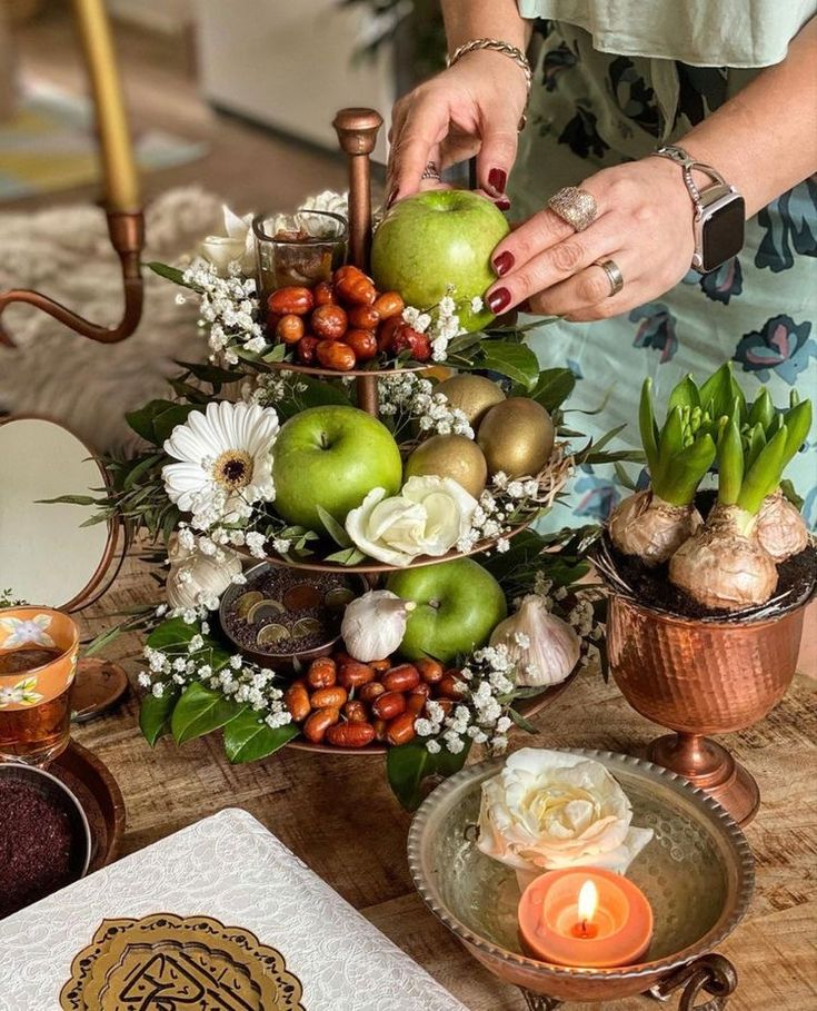 a table topped with lots of different types of fruit and flowers on top of it