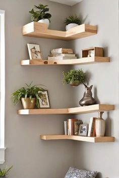 three wooden shelves with plants and books on them in the corner of a living room