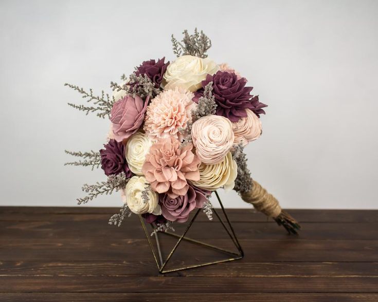 a bouquet of flowers sitting on top of a wooden table