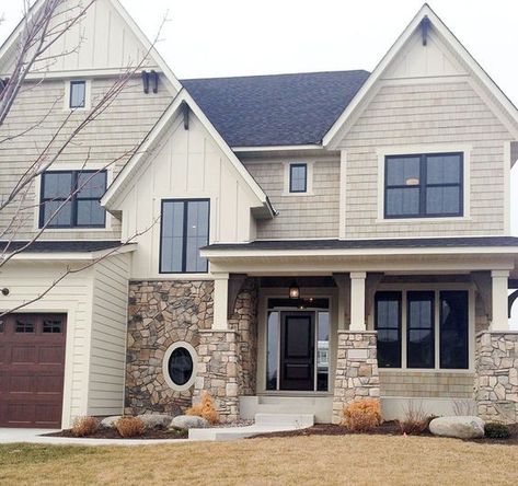 a large house with two garage doors and windows