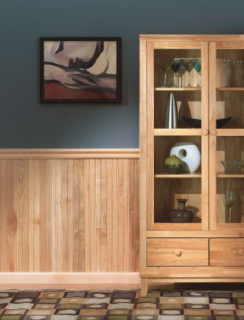 a wooden cabinet sitting next to a painting on the wall