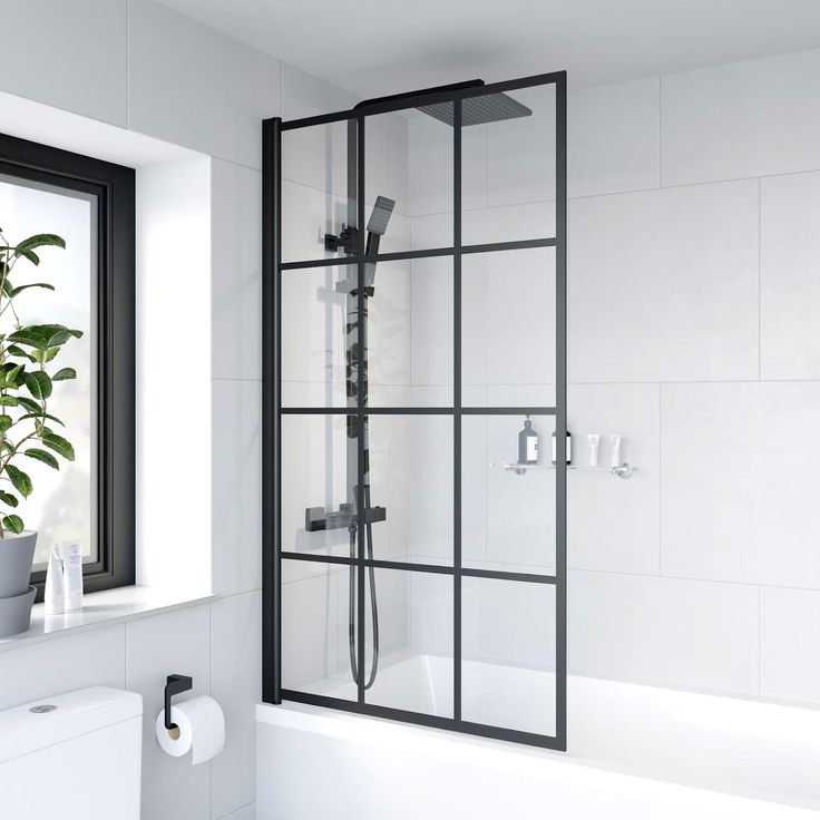 a bathroom with a toilet, tub and shower stall in white tiled walls next to a window