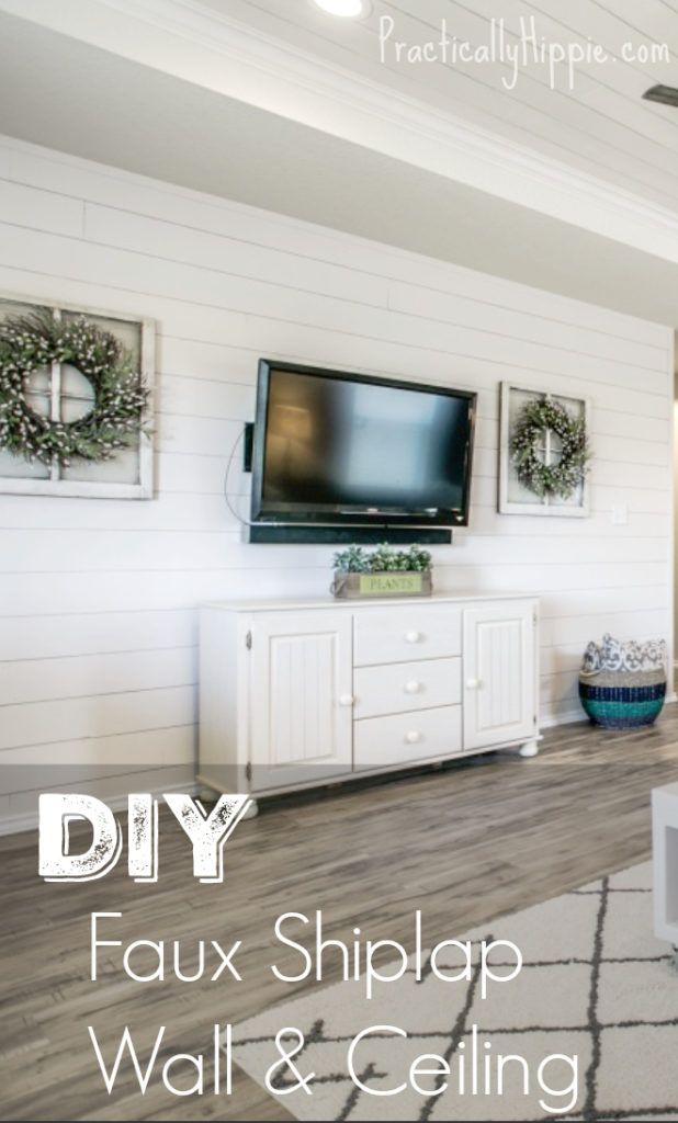 a living room with white walls and wood flooring is featured in the article diy faux shiplap wall & ceiling