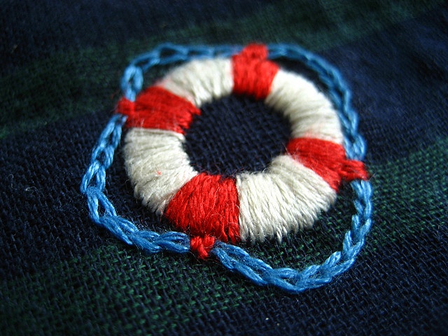 a red, white and blue piece of cloth with a ring on it's end