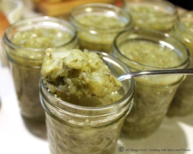 there is a spoon with some food in it on the table next to many jars